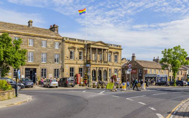 Skipton Town Hall_96 An exterior view of Skipton Town Hall with a rainbow pride flag flying on the flagpole.